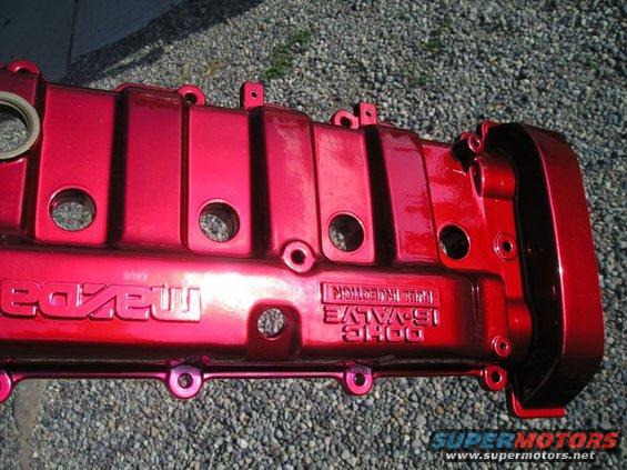 red painted engine valve cover with 'Mazda' and '16-VALVE FUEL INJECTION' text