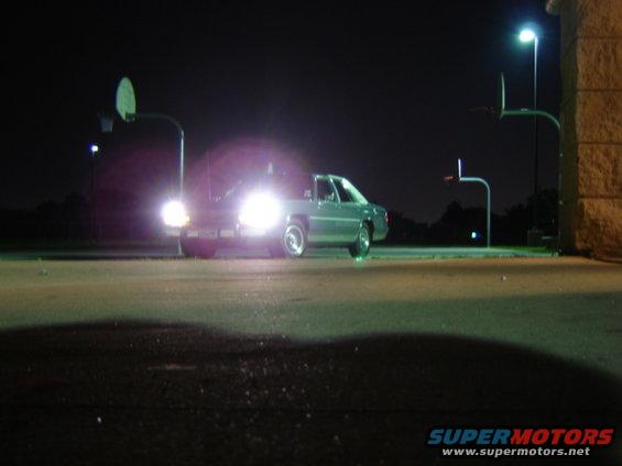 1988 Ford Crown Victoria LTD parked at night under streetlights, headlights on