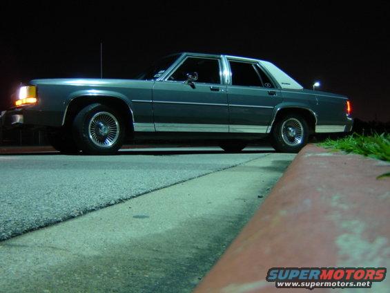 Gray 1988 Ford Crown Victoria LTD sedan parked curbside at night