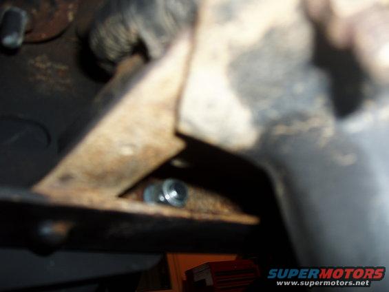 Rusty metal bracket with bolt