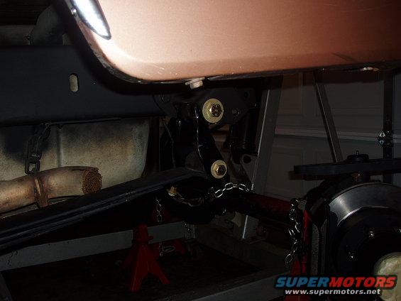 Undercarriage view of vehicle suspension and exhaust pipe