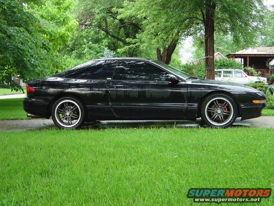 1994 Ford Probe coupe, side view, black paint, aftermarket wheels