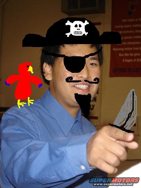 guy in pirate hat with eyepatch, fake mustache, goatee, holding a knife, with a red parrot on his shoulder