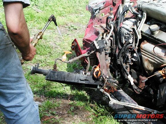 1992 Ford Taurus front end being cut with a torch