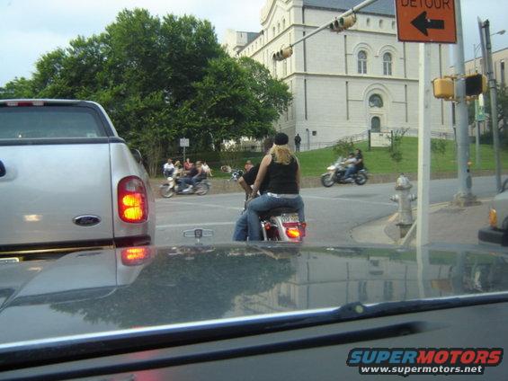 Motorcycles and a silver pickup truck on a city street
