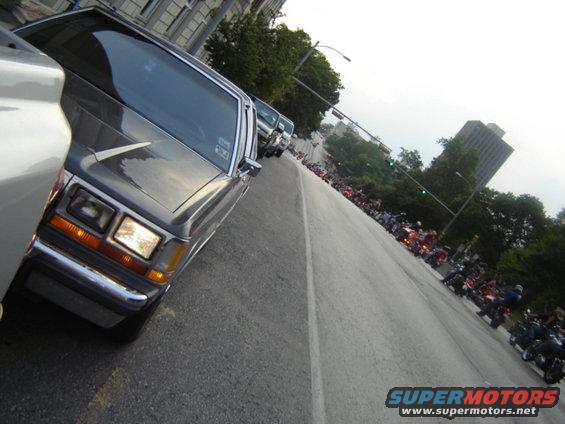 Gray 1988 Ford Crown Victoria LTD parked on street, many motorcycles in background