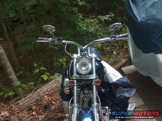 Motorcycle front end with chrome handlebars and headlight