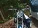 1976 Harley-Davidson Super Glide - Front view of a motorcycle, chrome handlebars, mirrors, and a headlight, partially covered.