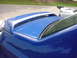 1998 Volkswagen Jetta - A blue car with racing stripes on its spoiler is parked next to another vehicle.