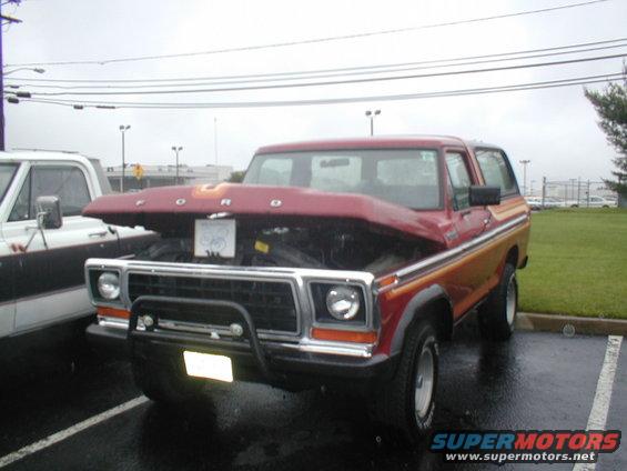 1979 Ford Bronco with hood open, parked next to another truck