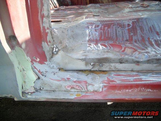 Red interior floor and door sill with primer and rust patches