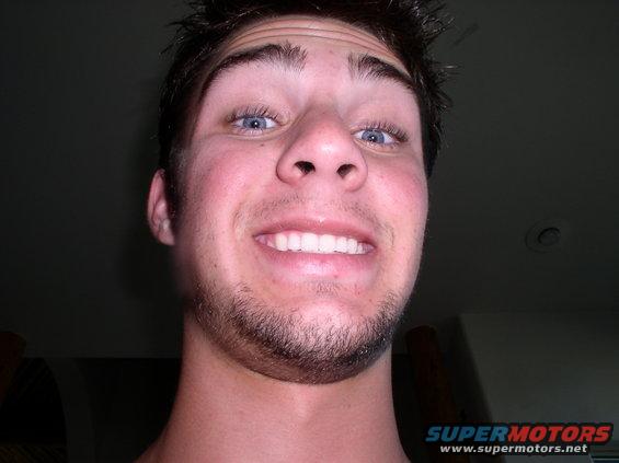 Close-up of a smiling man with blue eyes and a beard