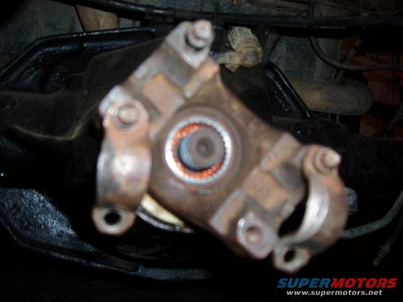 Close-up of a driveshaft U-joint with orange sealant visible