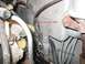 1994 Ford Bronco - Engine bay detail showing wiring and hoses, with instructions to remove a nut and stud.