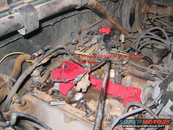 Engine bay with red rags, fuel lines, and electrical connectors. Text overlay reads "Use special tool to disconnect fuel lines"