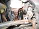 1994 Ford Bronco - Close-up view of an engine part, likely an EGR valve, with instructions to remove a nut and unscrew the valve.