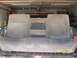 1999 Ford F-350 - A gray rear bench seat is visible in a garage, with a date stamp of 04/09/2004.