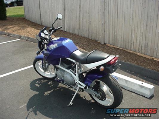 Purple Buell motorcycle parked in a lot, showing its side and rear