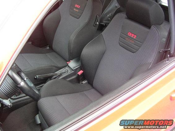 Car interior showing front Recaro seats with red GTI logos