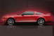 1990 Ford Bronco - Side view of a red Ford Mustang GT500, identifiable by its body style and GT 500 badging.