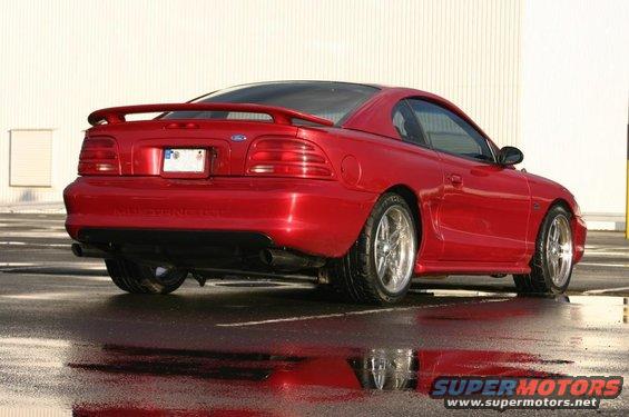 Red 1994 Ford Mustang coupe from rear, showing spoiler and taillights