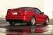 1990 Ford Bronco - Rear view of a red 1994 Ford Mustang coupe with a spoiler and custom wheels.