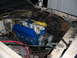 1985 Ford Crown Victoria LTD - The engine bay of a vehicle, showing a blue engine with extensive wiring and plumbing, suggesting ongoing maintenance or modification.