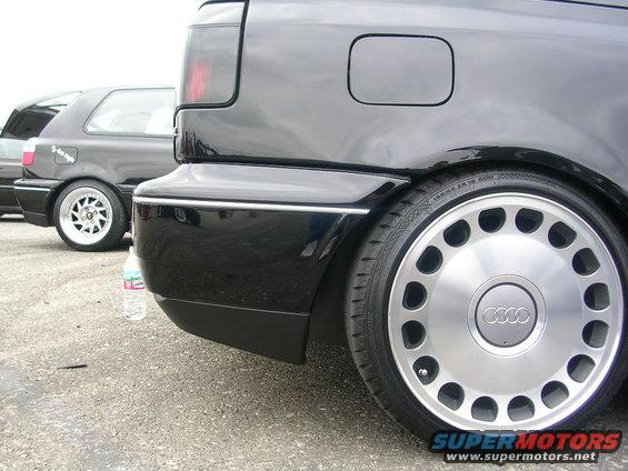 Black Audi rear quarter panel with unique multi-hole wheels