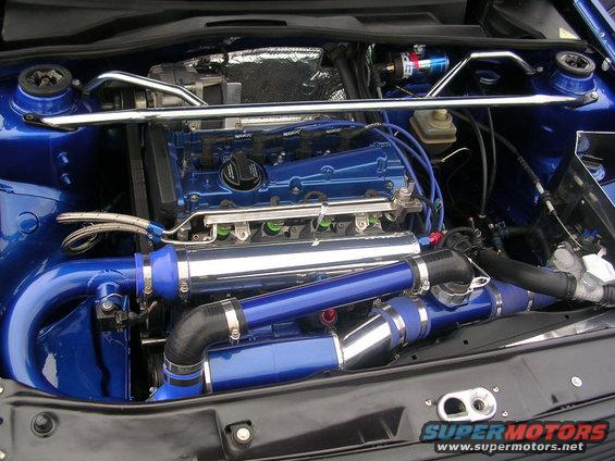 Customized blue engine bay with polished intake piping and intercooler