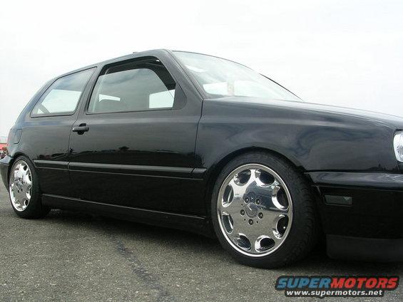 Black Volkswagen Golf Mk3, side profile, lowered with chrome wheels