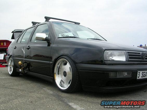 Black Volkswagen Golf Mk3 with chrome wheels and roof rack