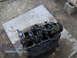 1978 Ford Bronco - The engine block is disassembled and resting on a piece of plywood on the ground.