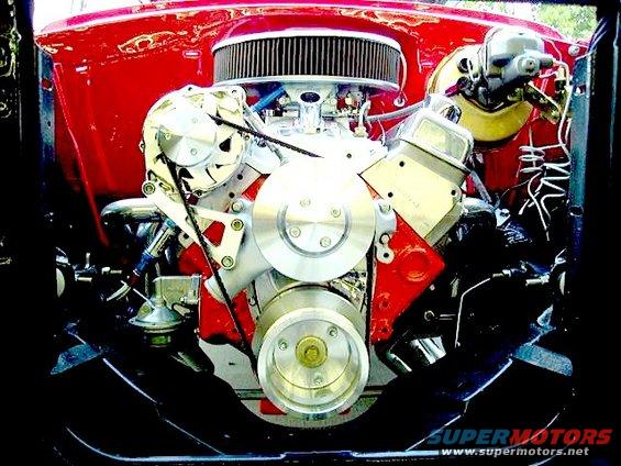 V8 engine with chrome air cleaner, pulleys, and red block