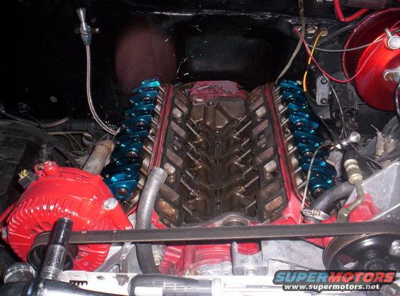 Engine with blue roller rockers and red alternator, viewed from above
