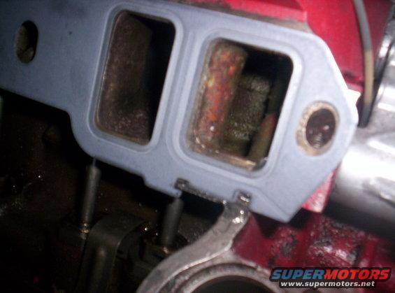 Intake manifold gasket installed on engine block, showing ports