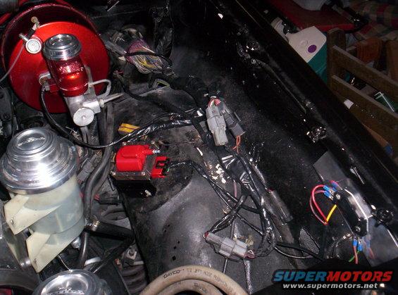 Engine bay with red brake booster and ignition coil