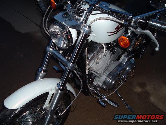 Front view of a white Harley-Davidson motorcycle with chrome accents. The engine and front fender are visible