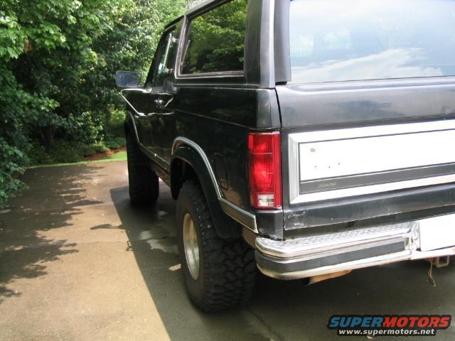 Black Ford Bronco, rear quarter view. Lifted with off-road tires