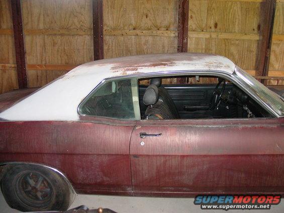 1969 Ford Fairlane coupe, maroon with white roof, side view, showing interior and worn paint