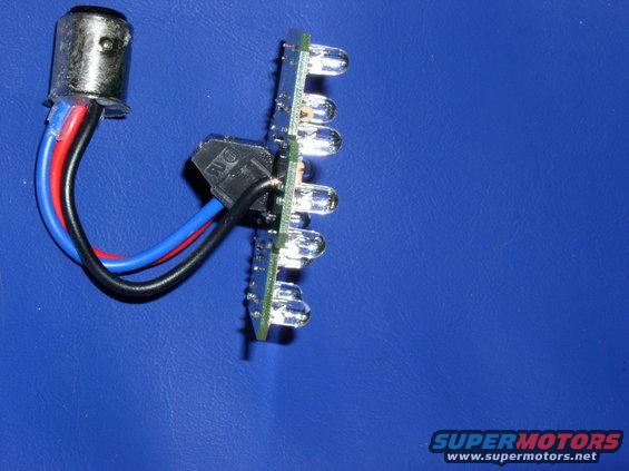 LED light strip with a bayonet base and wires, on a blue surface