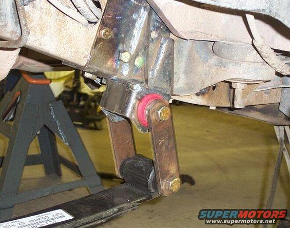 Rear hanger for front springs sectioned to reduce postive caster