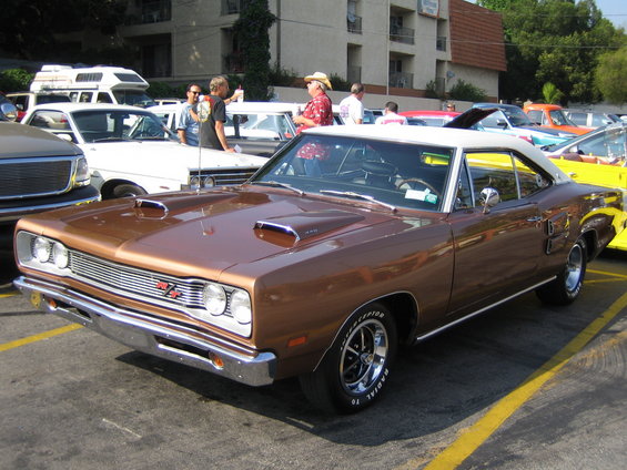 Brown 1969 Dodge Coronet R/T with hood scoops and white roof parked in a lot
