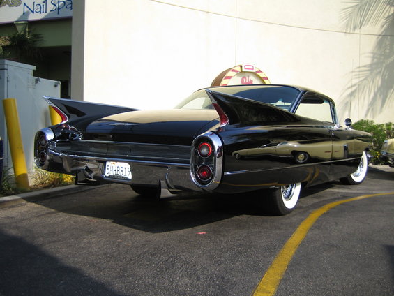 Black 1959 Cadillac Eldorado with tail fins and whitewall tires parked on asphalt