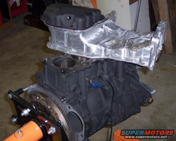 Engine block with intake manifold attached, mounted on an engine stand
