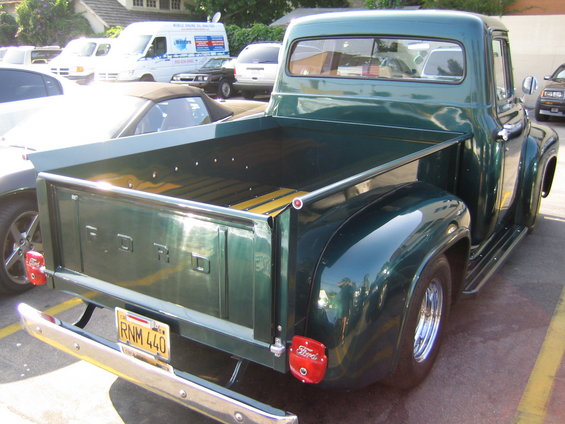 Green Ford pickup truck, rear view, chrome bumper, wooden bed, RNM 440 license plate