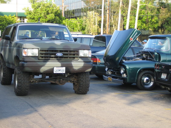 Camouflaged Ford Bronco SUV with lifted suspension and aftermarket wheels. License plate 4XBM588 is visible