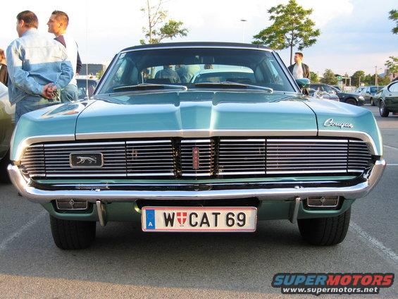 Front view of a teal Mercury Cougar with a chrome grille and a license plate that reads W CAT 69