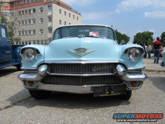 Light blue 1955 Cadillac front view with chrome grille and distinctive tail fins
