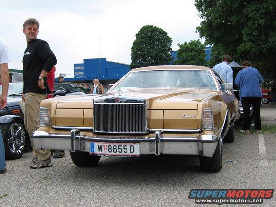 Gold Lincoln Continental Mark V with a large chrome grille and a license plate reading W 8655 D
