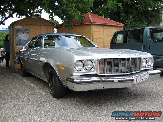 Silver sedan with a blue roof, chrome bumper, and a W license plate